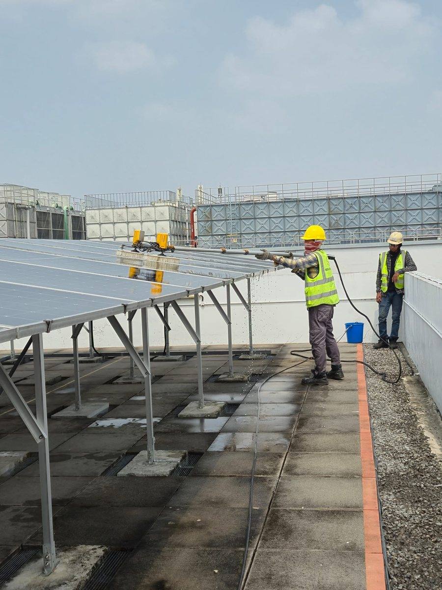Crew cleaning rooftop panels